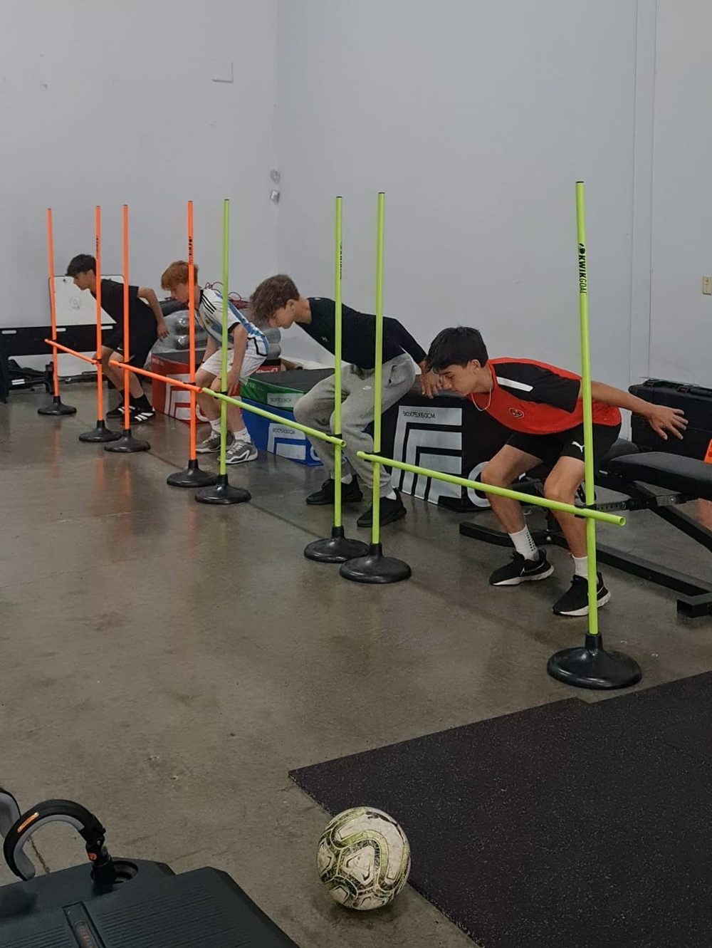 Group of youth athletes doing an agility drill
