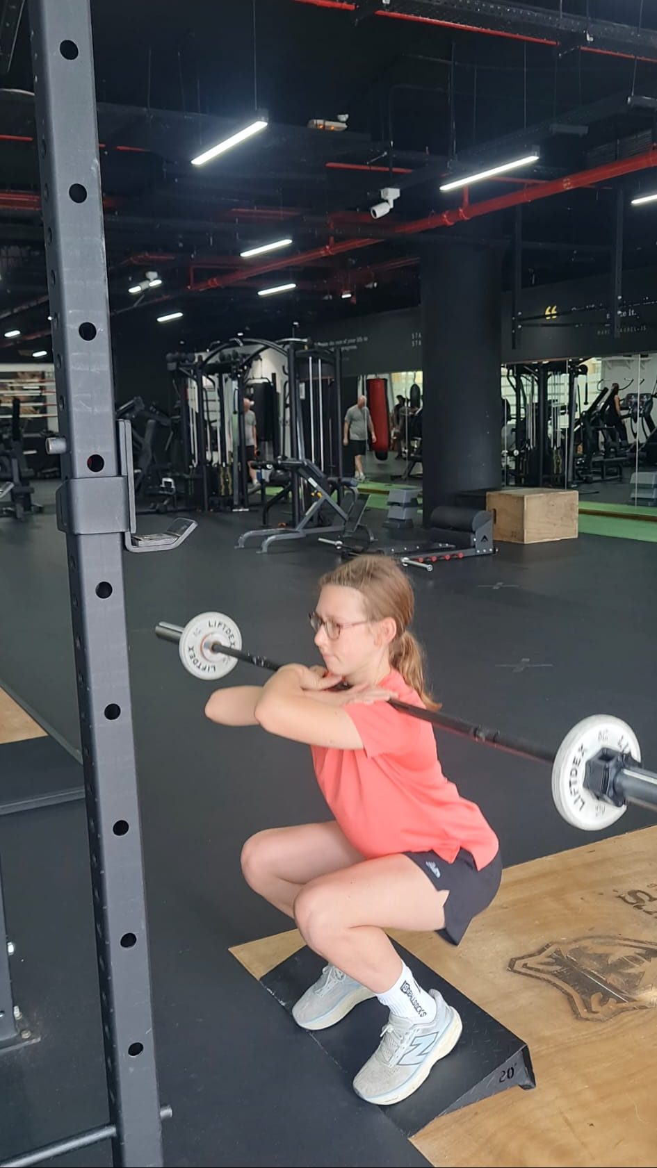 Young athlete front squatting